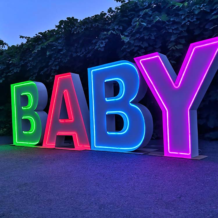 Factory team assembling large marquee letters for shipping